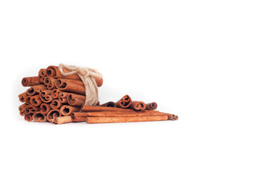 Ground cinnamon, cinnamon sticks, tied with jute rope on white background .