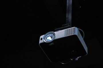 Multimedia projector hanging on the ceiling 
