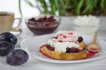 Toasted French bread with curd cream and plum jam.