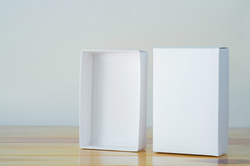 Empty white gift box for mock up on wooden table with copy space.