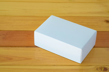 Empty white gift box for mock up on wooden table with copy space.