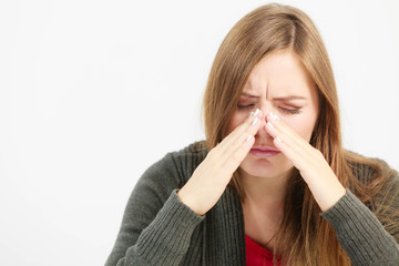 Young woman with painful sinus ache