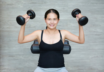 Fototapeta na wymiar Pregnant woman holding dumbbells in preparation for exercise.