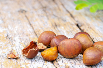 Chestnuts on wood table background.

