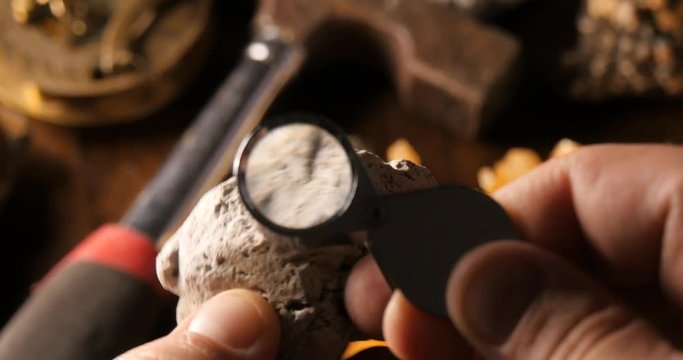 Volcanologist looking at volcanic pumice rock 