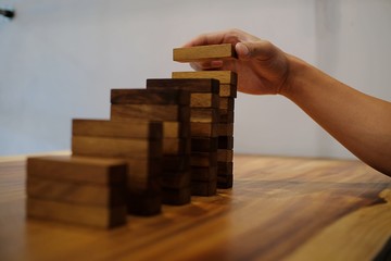 Planning risk and strategy in businessman gambling placing wooden block.Business concept for growth...