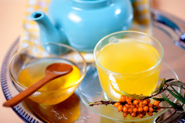Tea made from sea buckthorn berries healthy for health delicious, saturated with vitamins surrounded by berries and sea buckthorn leaves for family tea drinking and maintaining health in the body