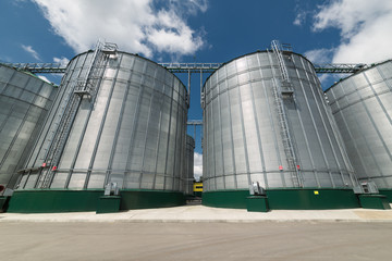 Large steel silos for storing barley and wheat.