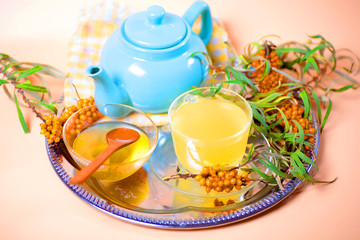 Tea made from sea buckthorn berries healthy for health delicious, saturated with vitamins surrounded by berries and sea buckthorn leaves for family tea drinking and maintaining health in the body