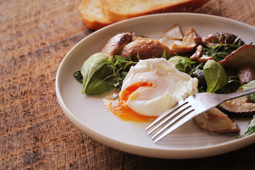 Benedict egg with spinach , mushrooms , bruschetta