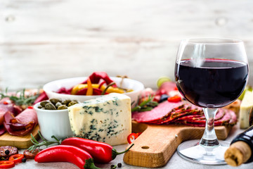 Restaurant with spanish table with food, wine, cheese and meat and vegetables, traditional tapas from spain