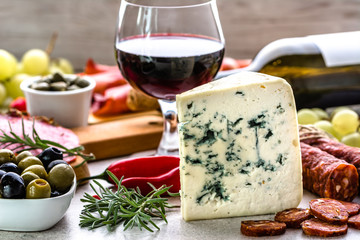 Blue cheese and wine snack set, italian antipasto or spanish tapas bar, selection of food on table...