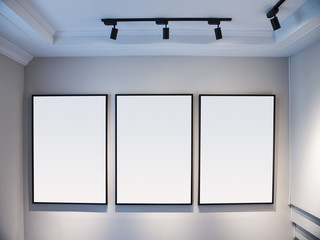 Mock up Blank Posters Frame display on white wall with spotlight Art gallery