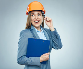 Thinking business woman builder holding  clipboard with contract.