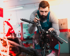 Worker repairing motorbike