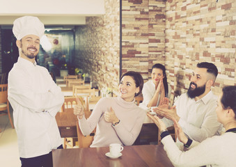 Professional chef listens to praise of the food