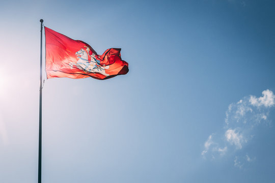 The coat of arms of Lithuania. Knight on a horse on a red background. Blue sky.
