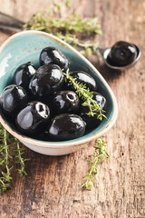 Bowl filled with fresh black olives