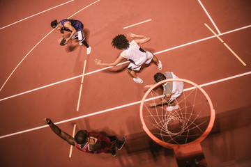 Guys playing basketball