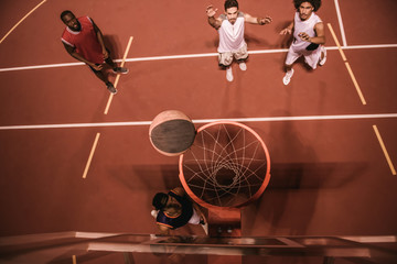 Guys playing basketball