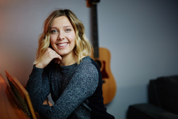 Fototapeta premium young blond woman next piano sitting