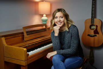 young blond woman next piano sitting © maxwellmonty