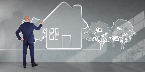 Businessman drawing sketch house plan project on a wall 3D rendering