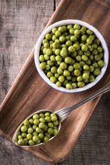 canned Green peas l on old wooden background,healthy vegan food
