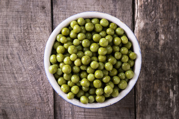 canned Green peas l on old wooden background,healthy vegan food