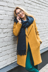 cheerful woman talking on smartphone