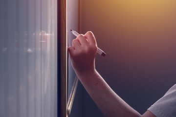 Left-hand female business person writing on office whiteboard