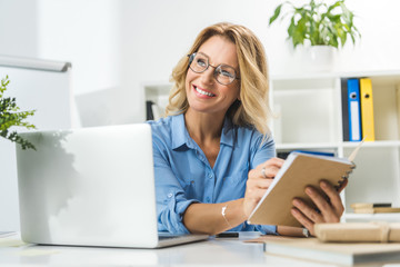 businesswoman writing in diary