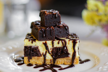 Homemade chocolate cheesecake topping brownie and dark chocolate sauce