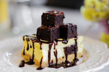 Homemade chocolate cheesecake topping brownie and dark chocolate sauce