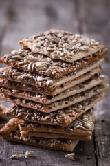Crunchy crispbread on a wooden background. Healthy snack: cereal crunchy multigrain cereal flax seed ,sesame, sunflower seeds protein bread bar.