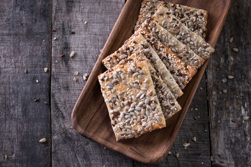 Crunchy crispbread on a wooden background. Healthy snack: cereal crunchy multigrain cereal flax...