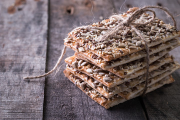 Crunchy crispbread on a wooden background. Healthy snack: cereal crunchy multigrain cereal flax...