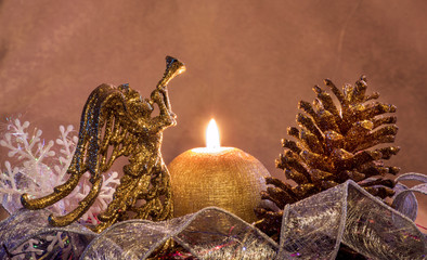 New-year composition with a candle by a gold cone and angel. Merry Christmas and Happy New Year!