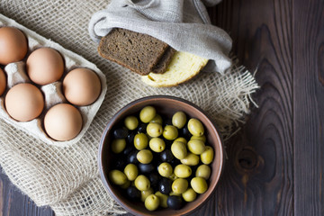 Fototapeta na wymiar eggs, bread, olives on a wooden table