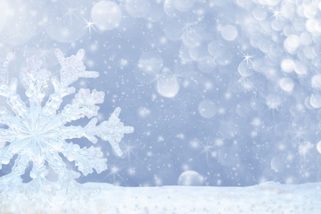 Big transparent snowflake in snow and beautiful bokeh with asterisks and snowfall.
