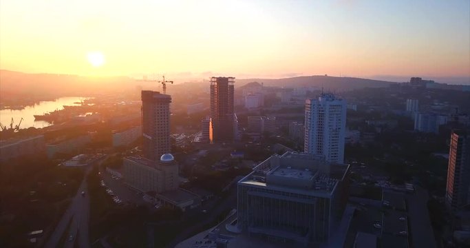 Aerial view of Vladivostok at the sunrise, view of new high buildings under construction, empty streets, and bay is on the left. Russia