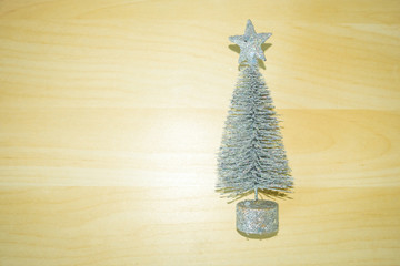 Glitter silver Christmas tree on beautiful wooden background