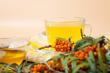 Tea made from sea buckthorn berries healthy for health delicious, saturated with vitamins surrounded by berries and sea buckthorn leaves for family tea drinking and maintaining health in the body