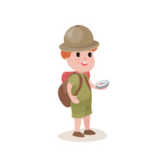 Young explorer with compass in hands and backpack on shoulders