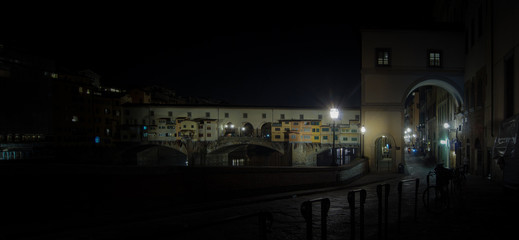 Street near the old bridge " Ponte Vecchio “,Florence , Italy