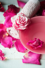 Obraz na płótnie Canvas Bowl of aroma spa water with rose petals on towel, closeup