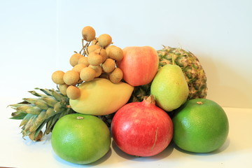 Still life of appetizing fruit, pineapple, pomegranate, lemon, apple, pear, kiwi, grapefruit, longan, long-kong