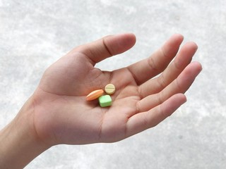 Colorful medicine in hands, blurred background