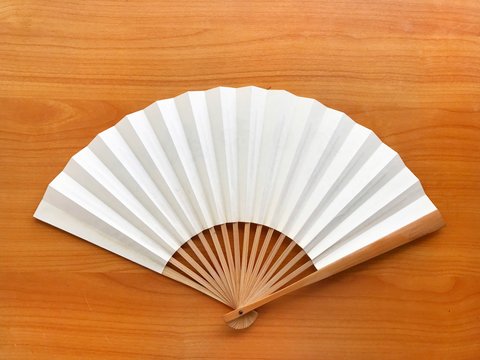 fan white chinese paper on wood floor and the space for the letter.