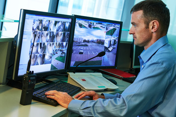 Security worker during monitoring. Video surveillance system.